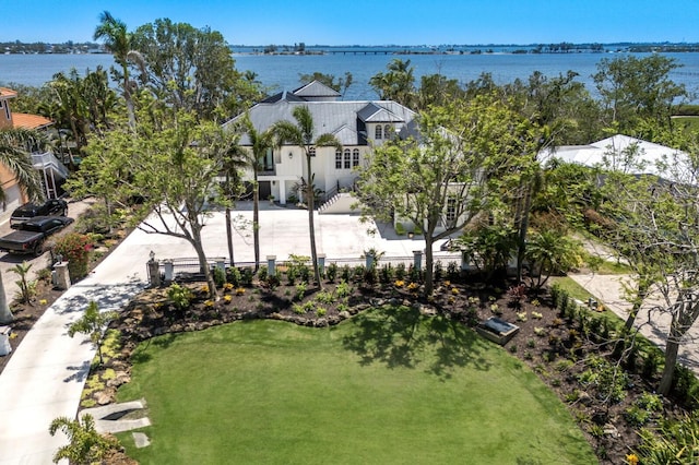 aerial view of property and surrounding area featuring a large body of water
