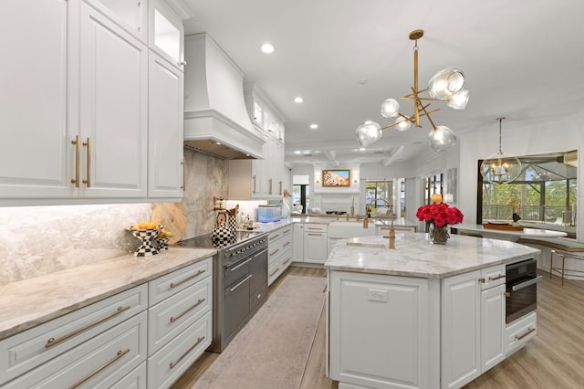 kitchen featuring a chandelier, custom exhaust hood, black oven, recessed lighting, and backsplash