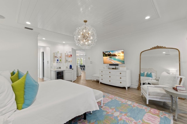 bedroom featuring a chandelier, ornamental molding, light wood-style floors, recessed lighting, and wine cooler