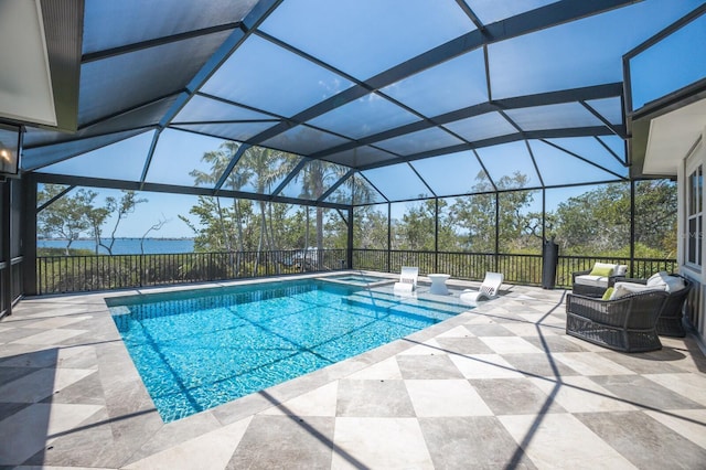 view of swimming pool featuring a patio, a pool with connected hot tub, and a lanai