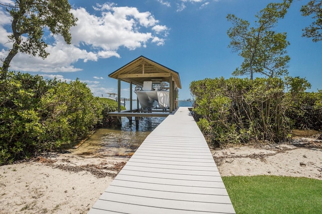dock area featuring boat lift and a water view