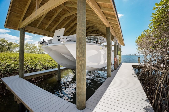 dock featuring boat lift and a water view