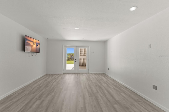spare room with light wood-style floors, baseboards, and recessed lighting