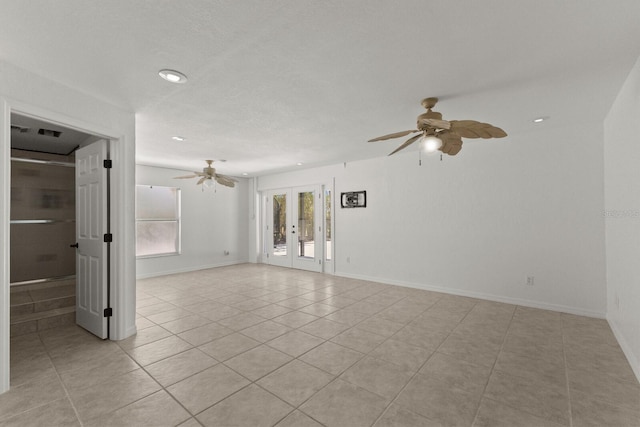 empty room with a ceiling fan, french doors, light tile patterned floors, recessed lighting, and baseboards