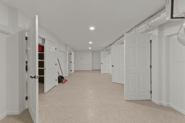 finished below grade area with baseboards, recessed lighting, and carpet