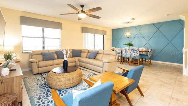 1450 Rolling Fairway Dr, Davenport, FL 33896 - living area featuring baseboards, a ceiling fan, and an accent wall