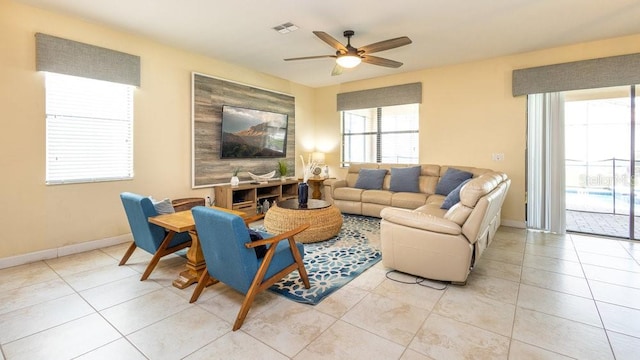 1450 Rolling Fairway Dr, Davenport, FL 33896 - living area featuring a ceiling fan, light tile patterned floors, and baseboards