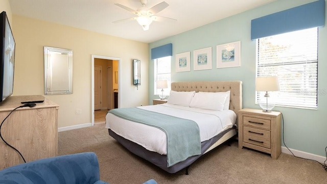 1450 Rolling Fairway Dr, Davenport, FL 33896 - bedroom with light carpet, baseboards, ceiling fan, and ensuite bath