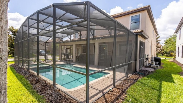 1450 Rolling Fairway Dr, Davenport, FL 33896 - back of house featuring a patio, a lanai, central air condition unit, a pool with connected hot tub, and stucco siding