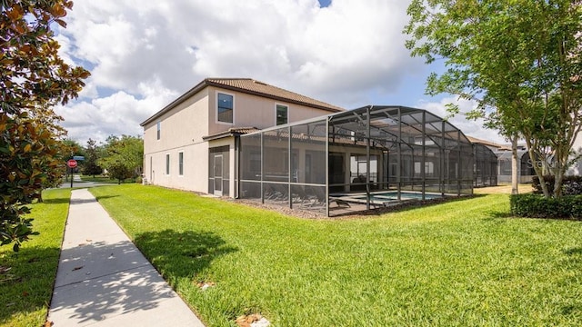 1450 Rolling Fairway Dr, Davenport, FL 33896 - rear view of house featuring a yard, an outdoor pool, stucco siding, and a lanai