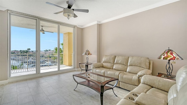 610 Riviera Dunes Way Unit 308, Palmetto, FL 34221 - living room featuring a ceiling fan, ornamental molding, and baseboards