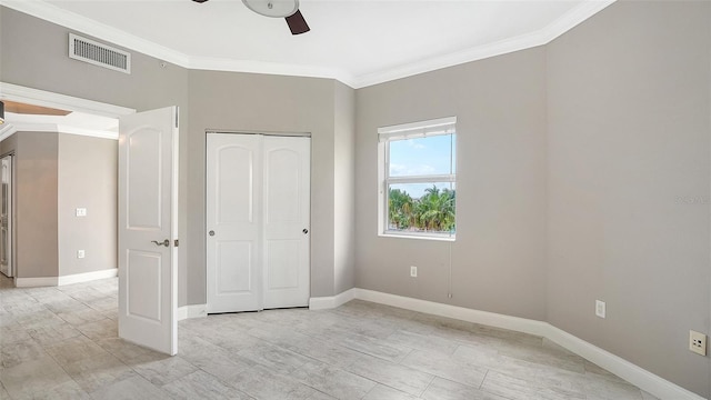 610 Riviera Dunes Way Unit 308, Palmetto, FL 34221 - unfurnished bedroom featuring ornamental molding, baseboards, a closet, and a ceiling fan