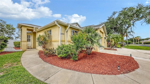 203 28th St W, Palmetto, FL 34221 - view of front of home with stucco siding and driveway