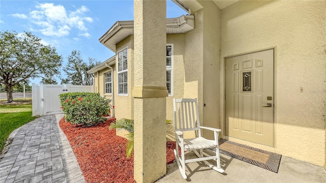 203 28th St W, Palmetto, FL 34221 - entrance to property featuring stucco siding, a gate, and fence
