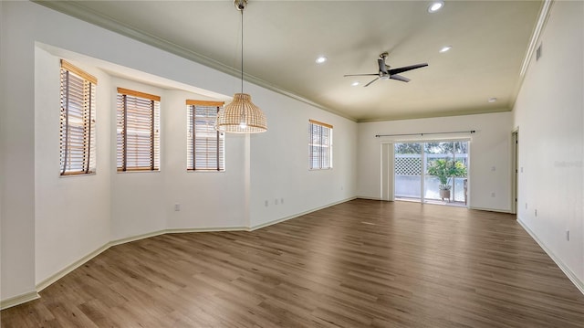 203 28th St W, Palmetto, FL 34221 - spare room with wood finished floors, ornamental molding, ceiling fan, recessed lighting, and baseboards