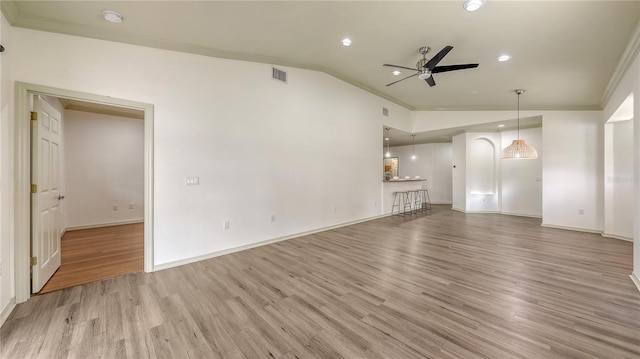 203 28th St W, Palmetto, FL 34221 - unfurnished living room with a ceiling fan, ornamental molding, light wood-type flooring, lofted ceiling, and baseboards