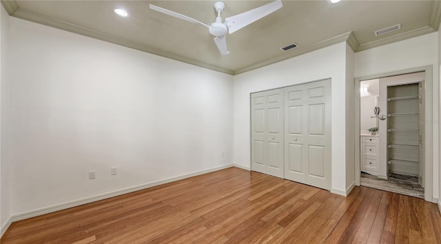 203 28th St W, Palmetto, FL 34221 - unfurnished bedroom with light wood-style floors, ornamental molding, recessed lighting, a closet, and baseboards
