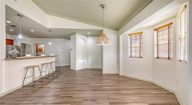 203 28th St W, Palmetto, FL 34221 - unfurnished dining area featuring crown molding, light wood-style floors, baseboards, recessed lighting, and vaulted ceiling