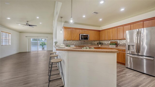 203 28th St W, Palmetto, FL 34221 - kitchen featuring stainless steel appliances, light wood finished floors, decorative backsplash, and recessed lighting