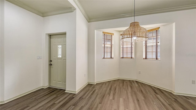203 28th St W, Palmetto, FL 34221 - unfurnished dining area with ornamental molding, wood finished floors, and baseboards