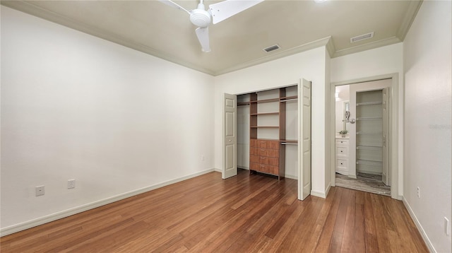 203 28th St W, Palmetto, FL 34221 - unfurnished bedroom with wood finished floors, crown molding, baseboards, a ceiling fan, and a closet