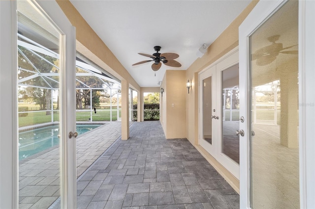 unfurnished sunroom with french doors, ceiling fan, and vaulted ceiling
