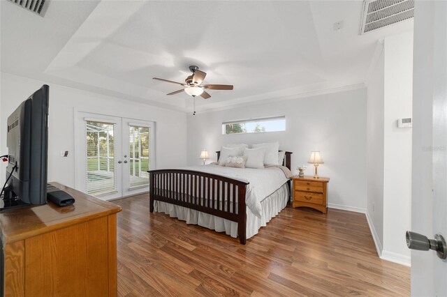 bedroom featuring french doors, access to outside, wood finished floors, ornamental molding, and baseboards