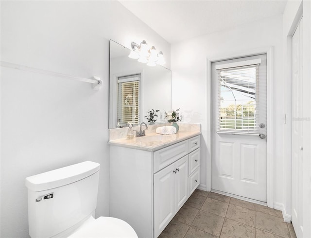 bathroom featuring toilet and vanity