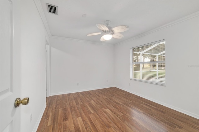 unfurnished room featuring wood finished floors, crown molding, a ceiling fan, and baseboards