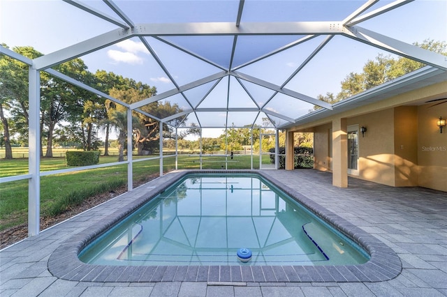 swimming pool with a patio, a yard, and a lanai