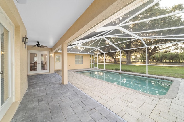 outdoor pool with french doors, a patio, ceiling fan, and a lawn
