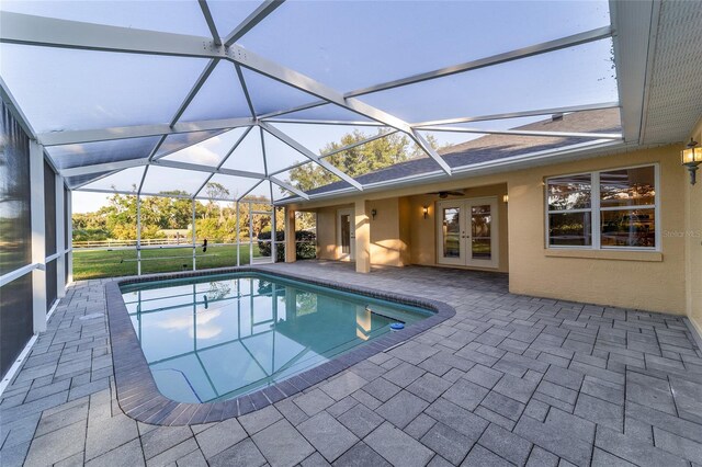swimming pool featuring french doors, a patio area, ceiling fan, and a lanai