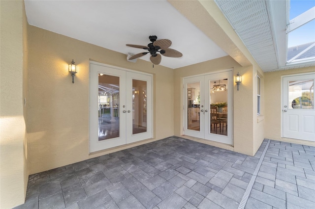 doorway to property featuring french doors, a patio, ceiling fan, and stucco siding