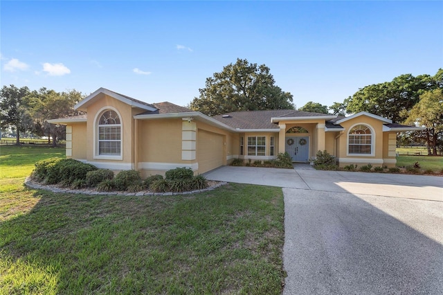 ranch-style home with stucco siding, an attached garage, concrete driveway, and a front lawn
