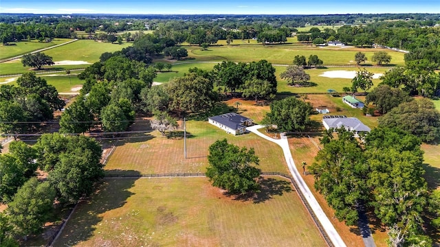 aerial view of sparsely populated area featuring a tree filled landscape