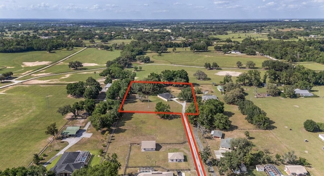 aerial view of property and surrounding area with property parcel outlined and a tree filled landscape