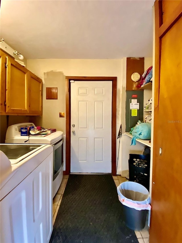 kitchen with independent washer and dryer, light tile patterned floors, light countertops, and brown cabinetry