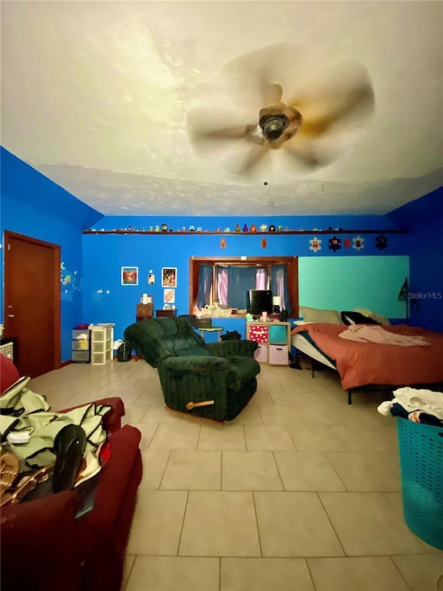 bedroom with tile patterned floors, lofted ceiling, and ceiling fan