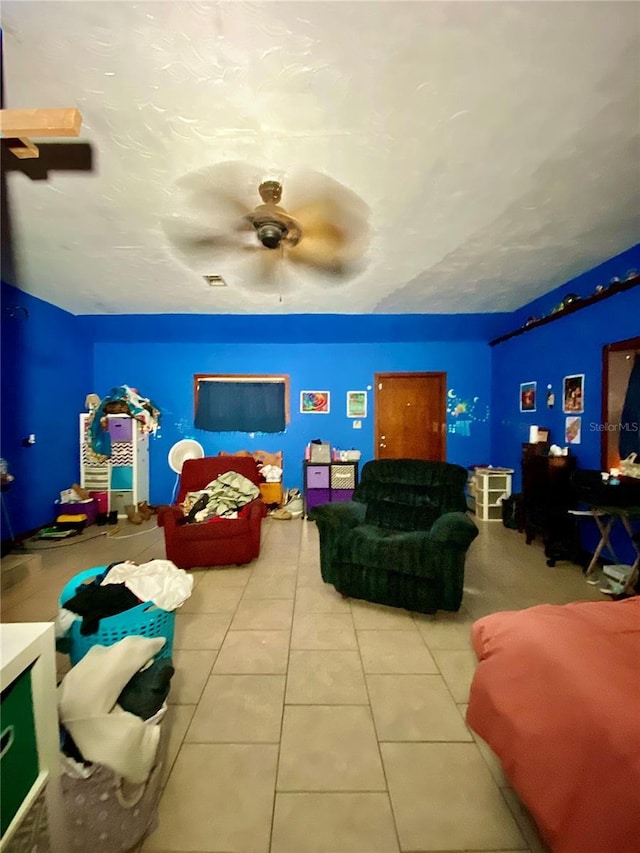 rec room featuring a ceiling fan and tile patterned floors