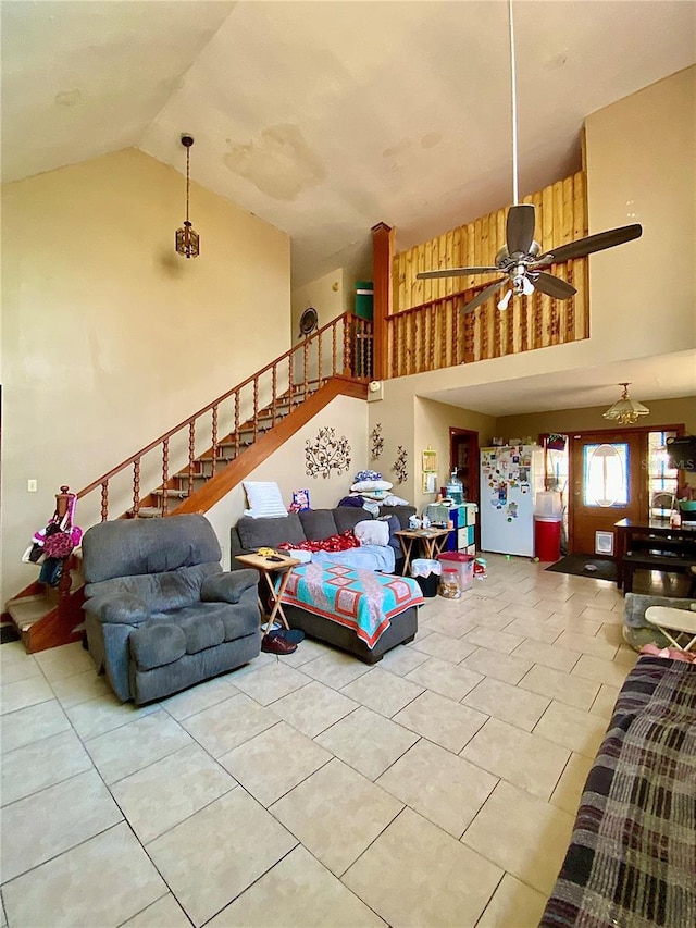 living room featuring tile patterned floors, high vaulted ceiling, stairs, and ceiling fan