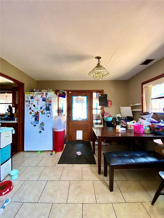 entryway featuring plenty of natural light and light tile patterned flooring