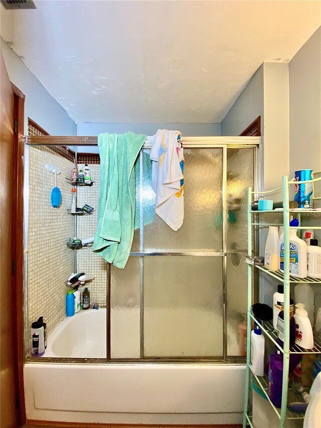 full bathroom featuring combined bath / shower with glass door