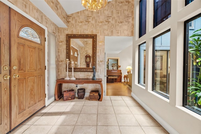 140 Cowpen Ln, Sarasota, FL 34240 - foyer entrance with baseboards, light tile patterned flooring, a chandelier, and wallpapered walls