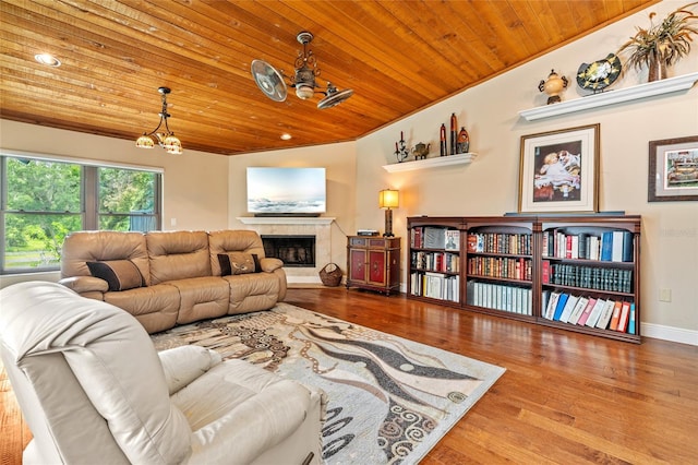 140 Cowpen Ln, Sarasota, FL 34240 - living area with wood ceiling, a chandelier, wood finished floors, a fireplace, and baseboards