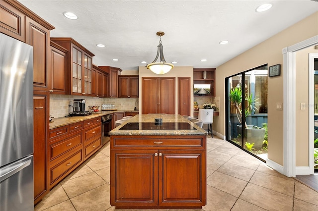 140 Cowpen Ln, Sarasota, FL 34240 - kitchen featuring freestanding refrigerator, black electric stovetop, tasteful backsplash, light stone countertops, and wall oven