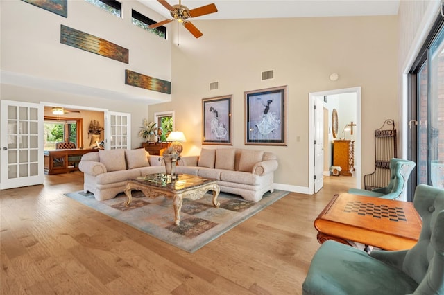 140 Cowpen Ln, Sarasota, FL 34240 - living area featuring french doors, a ceiling fan, high vaulted ceiling, light wood-style floors, and baseboards