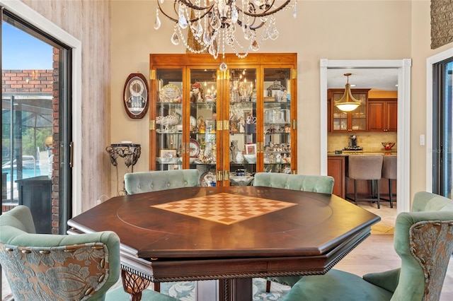 140 Cowpen Ln, Sarasota, FL 34240 - dining area with a chandelier, plenty of natural light, and light wood-style floors