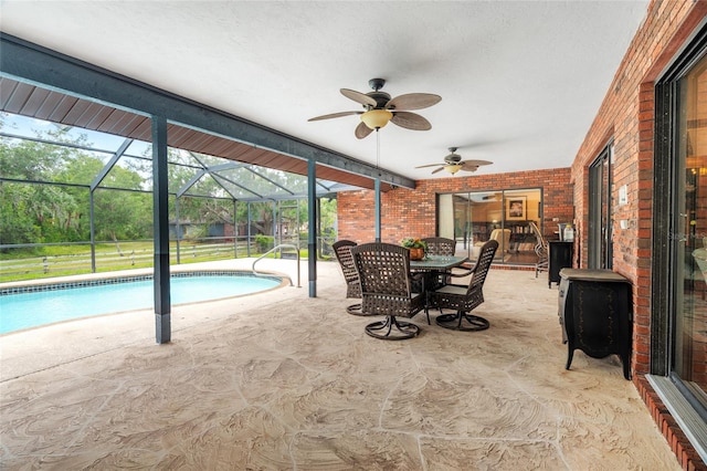 140 Cowpen Ln, Sarasota, FL 34240 - outdoor pool with a patio area, ceiling fan, glass enclosure, and outdoor dining area