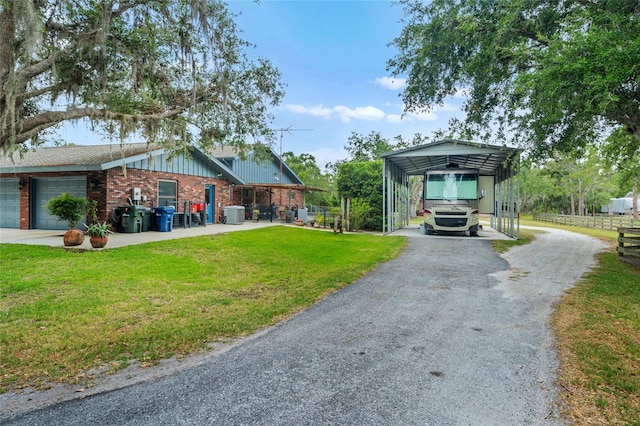 140 Cowpen Ln, Sarasota, FL 34240 - view of front of house with asphalt driveway, board and batten siding, a carport, cooling unit, and brick siding