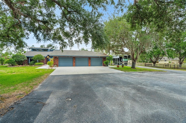 140 Cowpen Ln, Sarasota, FL 34240 - view of front of home featuring asphalt driveway and a garage